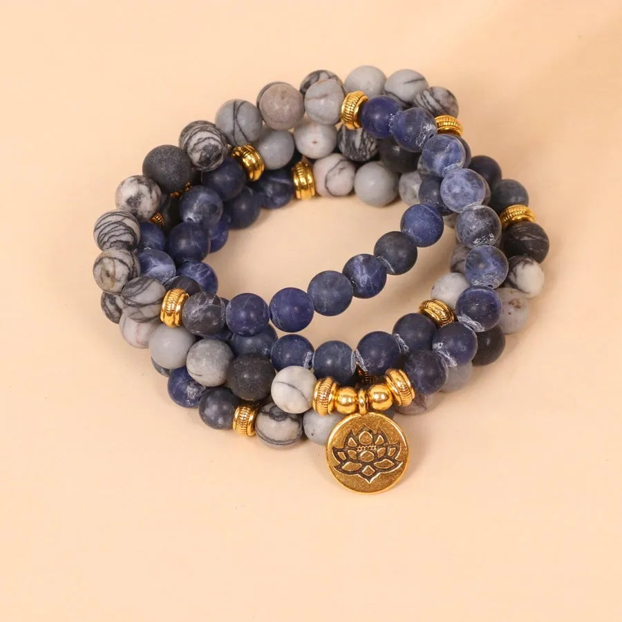 Blue patterned network stone beads on a multi-layer bracelet with an alloy clasp.