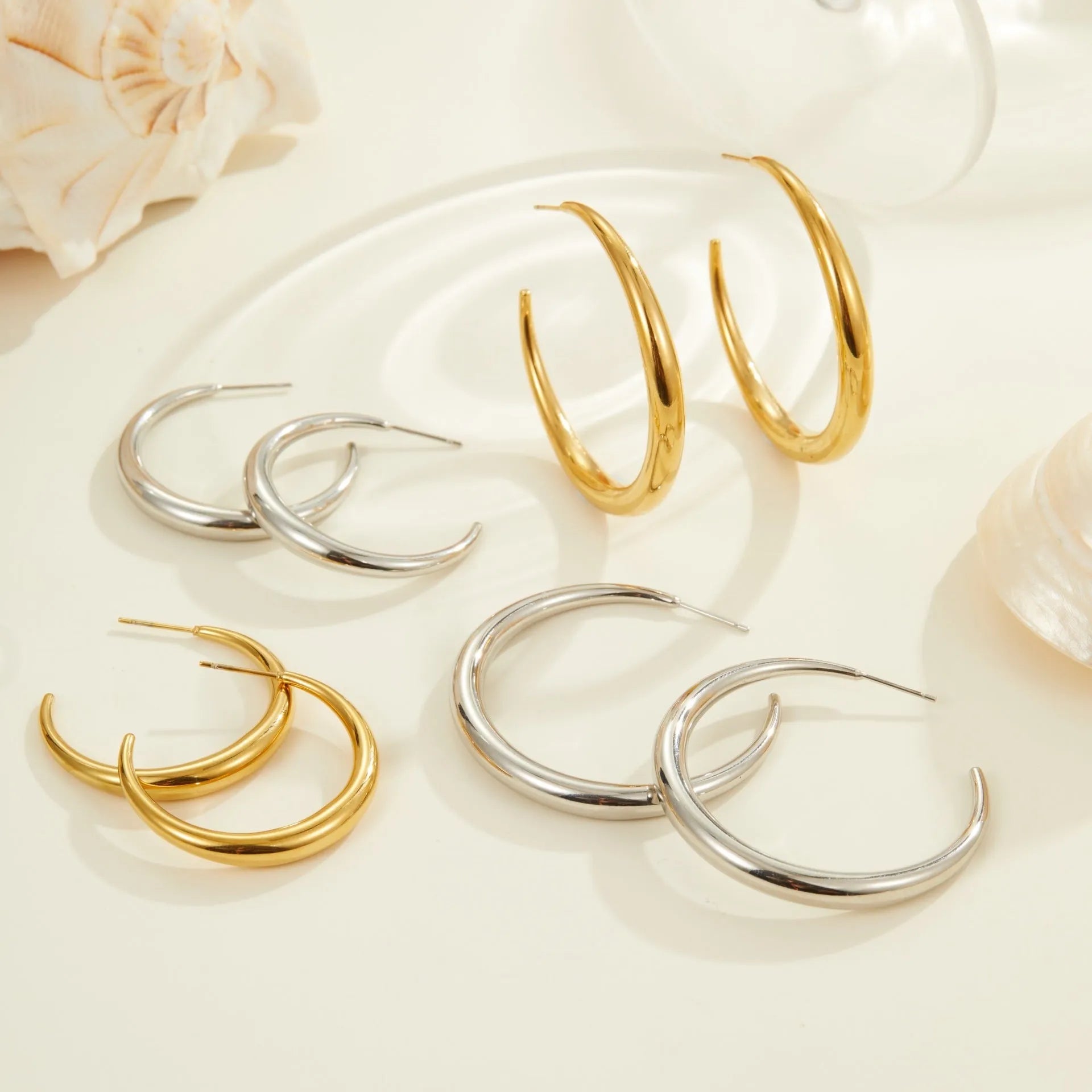 Titanium steel hoop earrings with geometric round design in gold and steel finish options