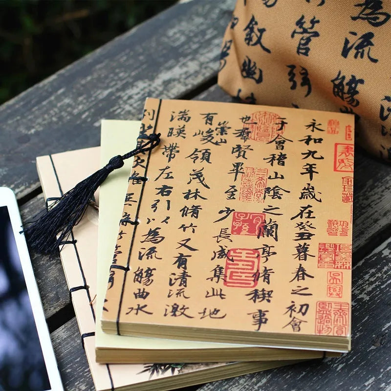 A5 antique wire-bound notebook with glossy embossed cover featuring a retro painting design, shown open.