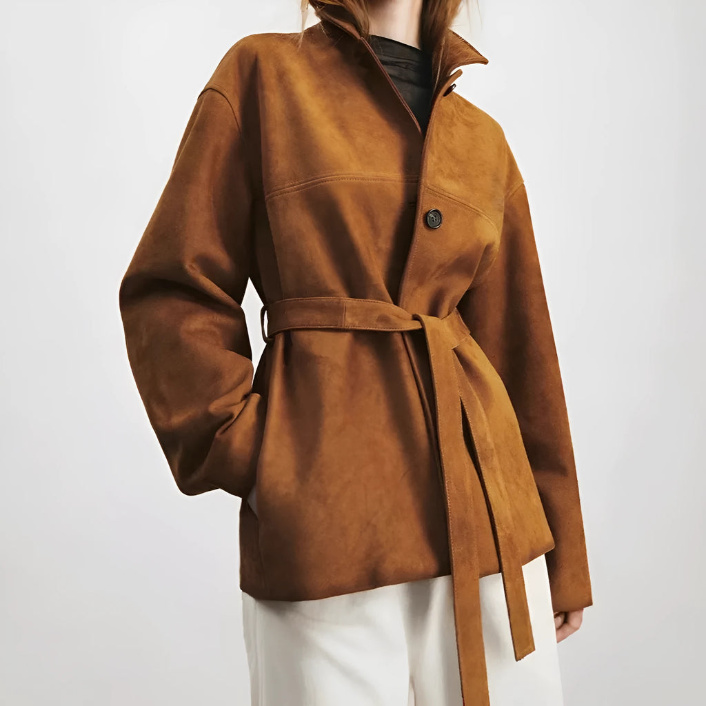 Yellow brown retro-style leather cashmere coat with Peter Pan collar and belt on a hanger.