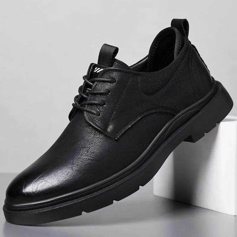 Men's black and brown breathable leather casual shoes with rubber sole and sewing line detail.