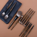 A 12-piece makeup brush set with soft bristles and wooden handles in a PU brush bag