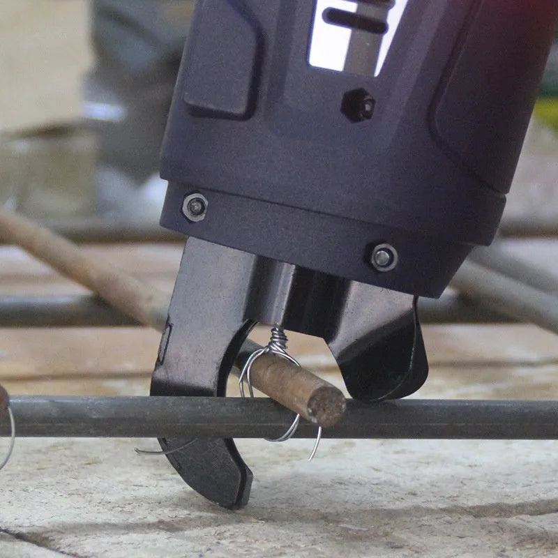 Fully automatic electric steel bar tying machine with battery, charger, and toolbox on a construction site.
