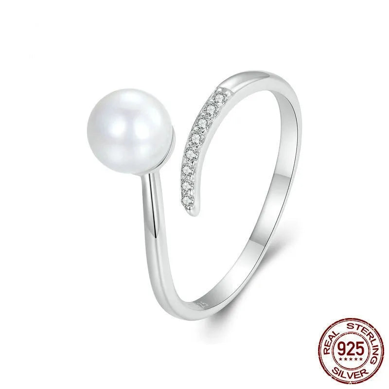 Silver adjustable ring with natural pearl centrepiece showing open loop design