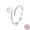 Silver adjustable ring with natural pearl centrepiece showing open loop design