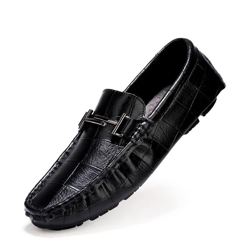 Men's black leather casual shoes with a silver buckle on a flat rubber sole.