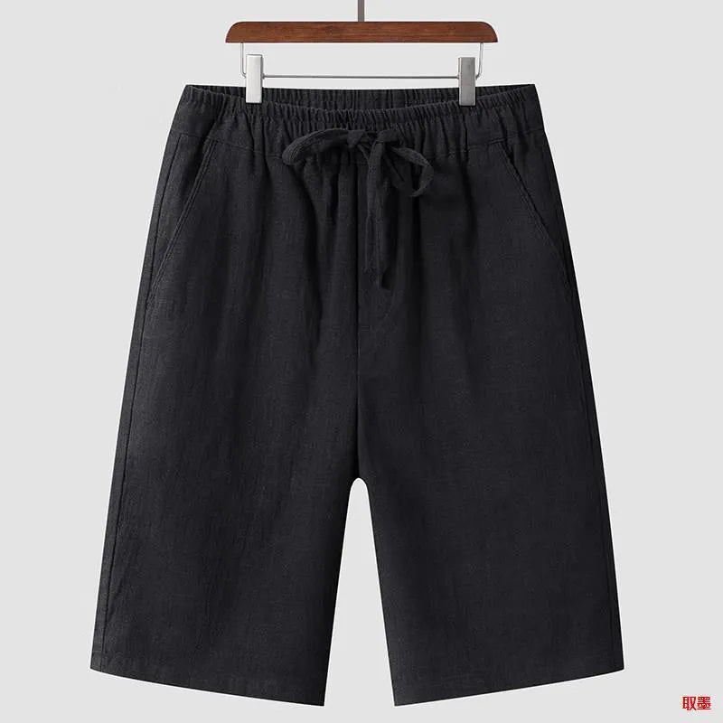 Men's beige linen shorts with a loose cropped fit and mid waistband.