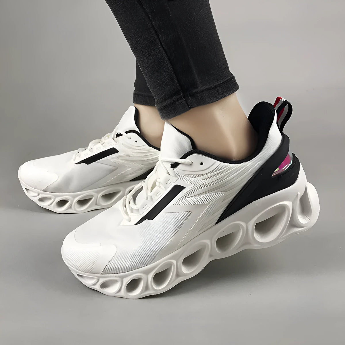 Breathable low-top mesh casual trainers in black on a white background, showing lace-up front and round toe.