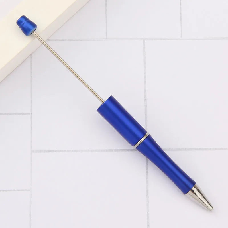 Ballpoint pen with colourful spinning plastic beads on barrel, shown in a gradient purple finish.