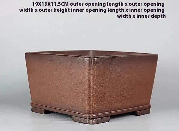 Handmade brown antique purple clay flower pot for plants on a windowsill.