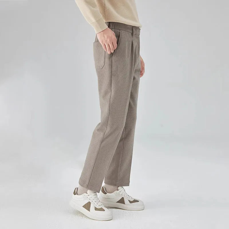 Men's straight-leg corduroy trousers in beige, black, and brown grey, showing mid-waist and micro elastic fabric detail.