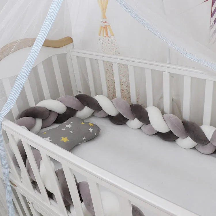 Braided knot design baby crib bumper in spandex velvet, shown in a light grey colour.