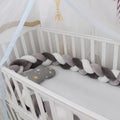 Braided knot design baby crib bumper in spandex velvet, shown in a light grey colour.