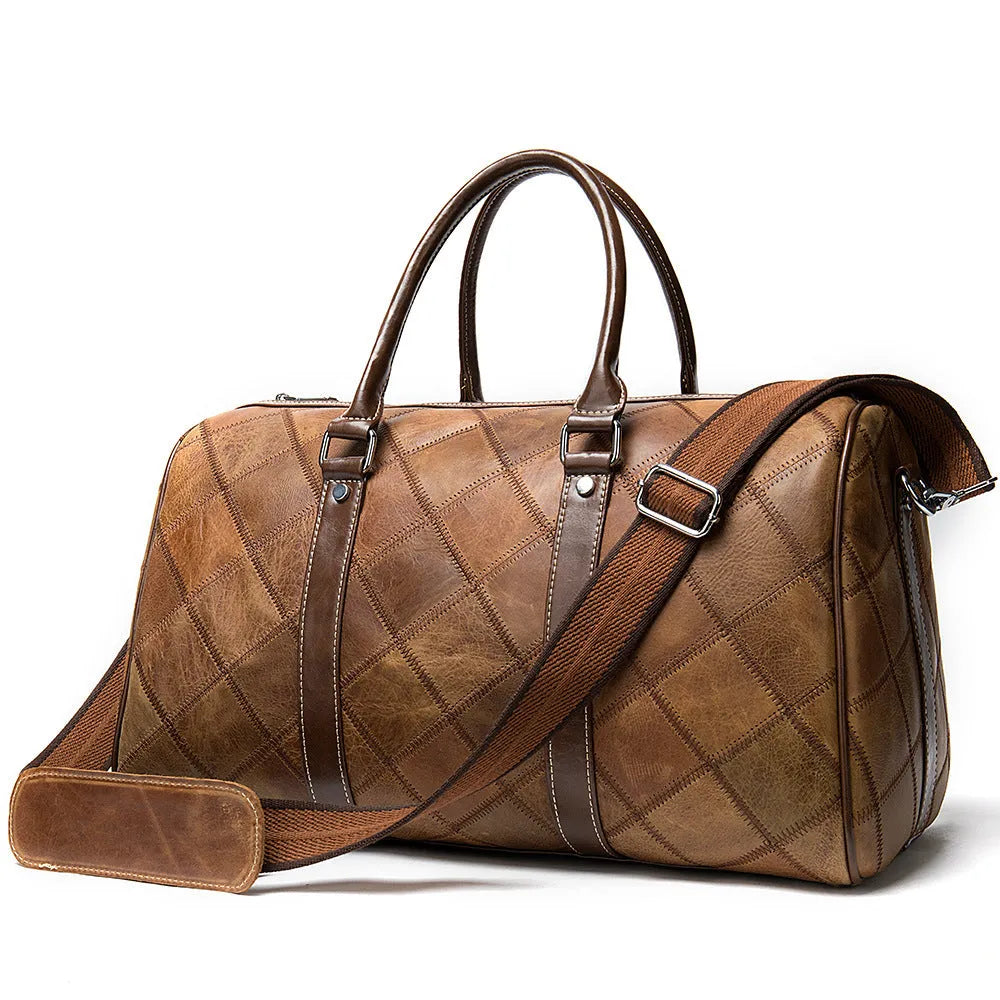 Vintage brown cowhide leather men's duffel bag with a single shoulder strap.
