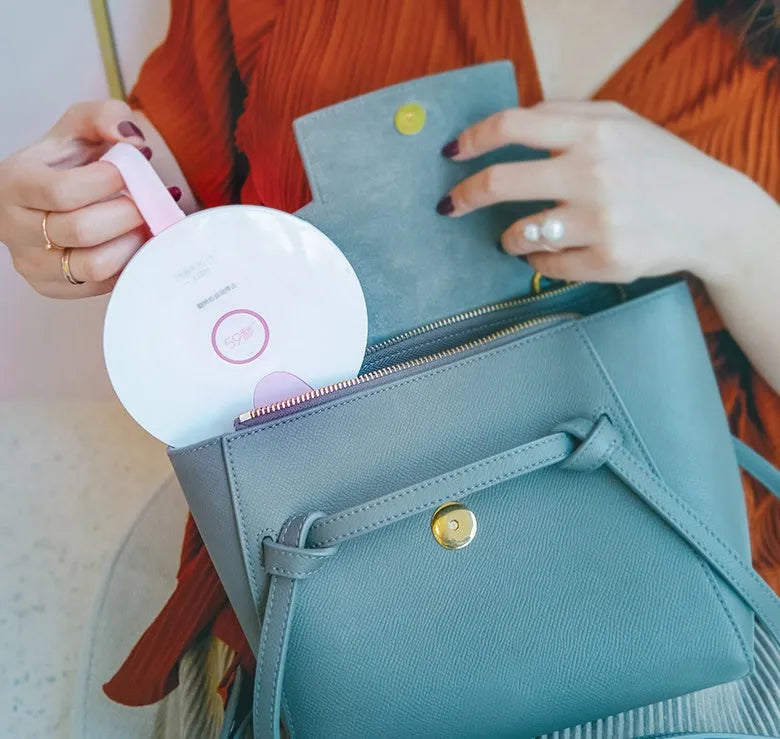 A slim, portable UV baby bottle steriliser in blue, showing its compact size and USB charging port.