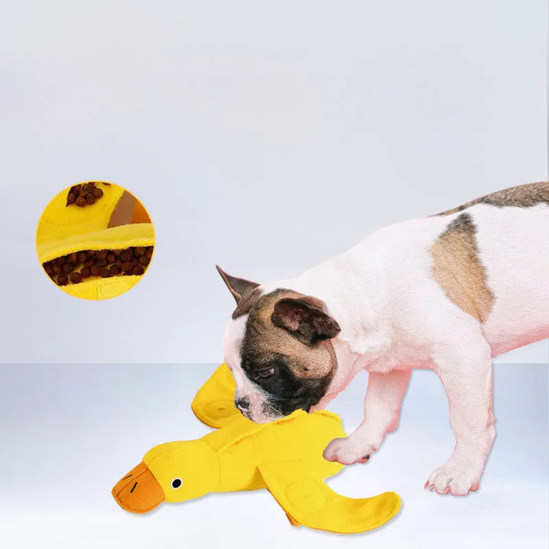 Yellow plush teddy dog toy with attached duck doll and food leak compartments for pet training