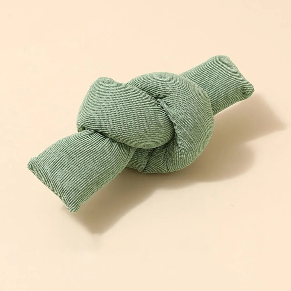 White knotted cotton dog rope toy for tugging and chewing.
