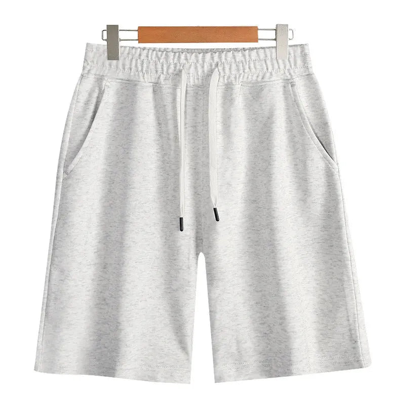 Men's straight leg cotton sports shorts in a light grey colour, showing a relaxed fit suitable for summer.
