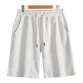 Men's straight leg cotton sports shorts in a light grey colour, showing a relaxed fit suitable for summer.