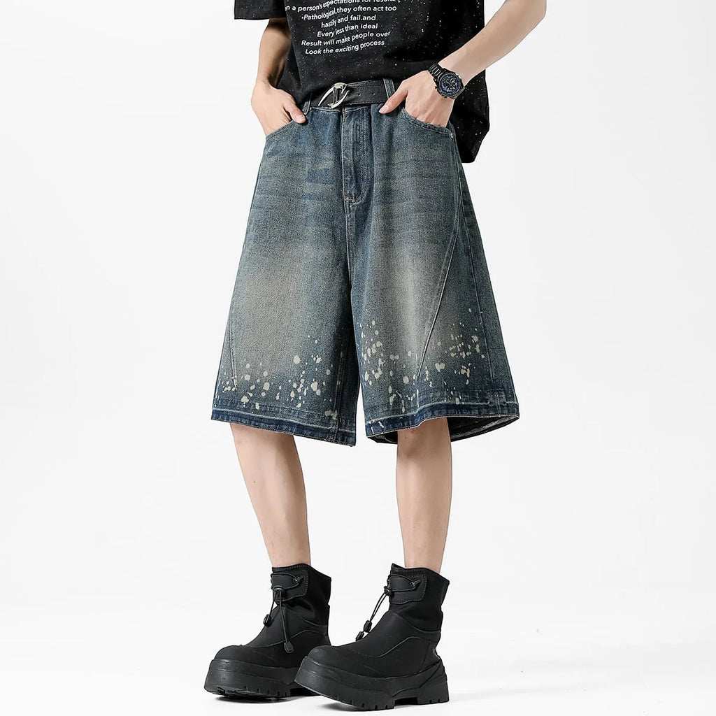 Retro blue washed denim shorts for men with ripped splash ink details and a straight leg cut.