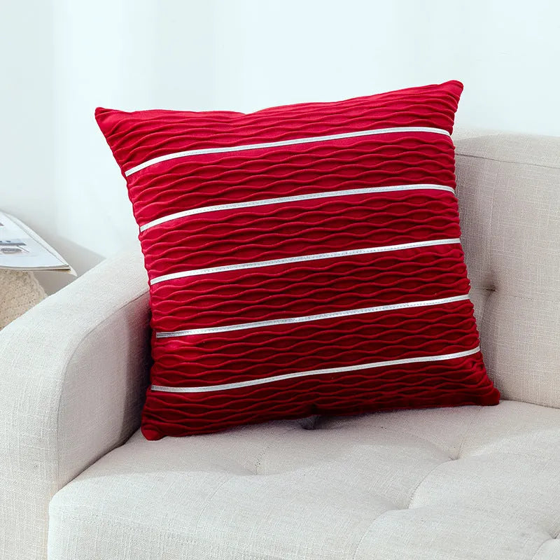 Square striped velvet plush cushion cover in a selection of colours on a sofa.