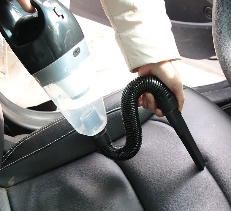 Orange, black, and blue coloured 12V portable handheld car vacuum cleaner with nozzles and power cord.