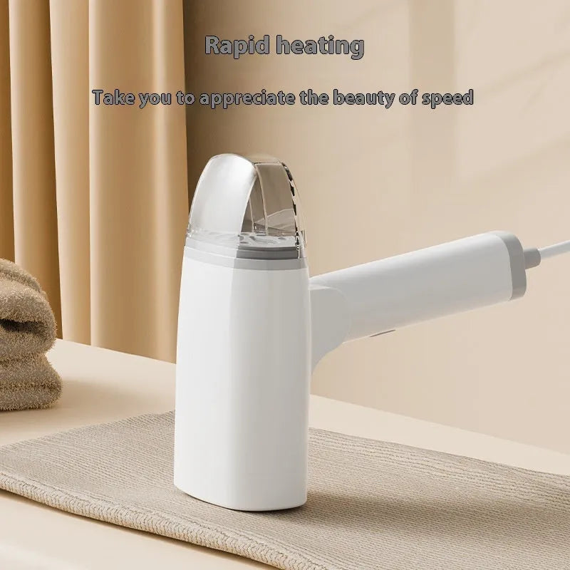 Blue and white handheld garment steamer with hanging iron attachment on wooden surface