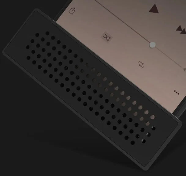 ABS mini mobile phone amplifier bracket in pink, holding a smartphone horizontally on a desktop.