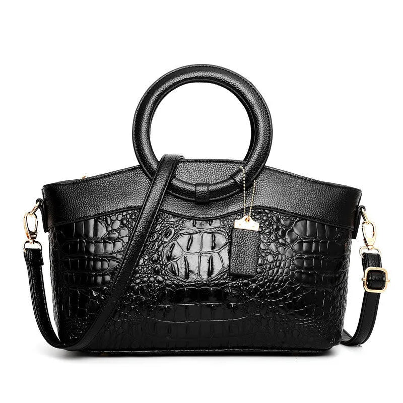 Fabric women's shoulder handbag in multiple colours showing zipper pockets and organisational compartments.