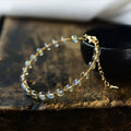 Women's bracelet with blue moonstone beads and gold-gilded metal in a starry sky design.