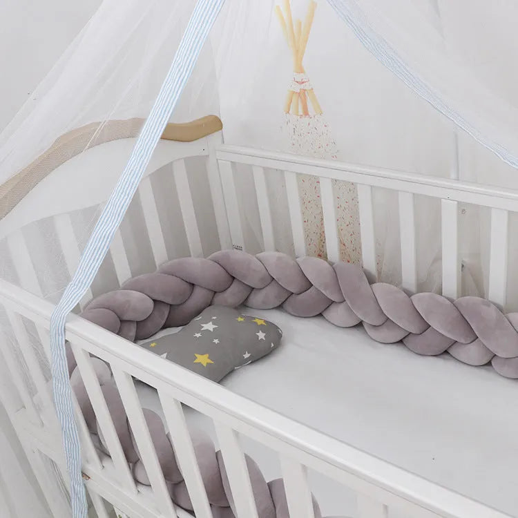 Braided knot design baby crib bumper in spandex velvet, shown in a light grey colour.