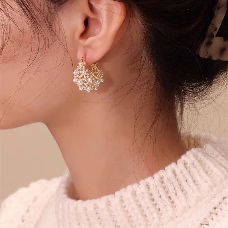Gold-coloured women's flower basket earrings with small rice-shaped beads and pearl inlay on copper.