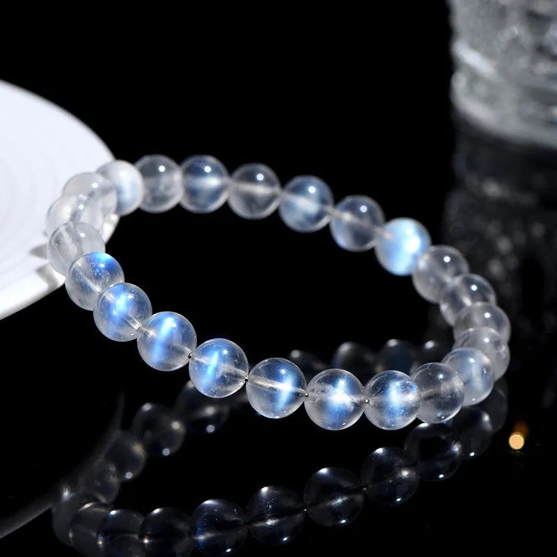 Natural cream body blue moonlight crystal bracelet shown in a simple unisex design on a wrist.