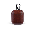 Genuine leather protective case sleeve for Apple Airpods charging case in black, brown, light brown, and red.