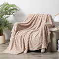 Polyester velvet jacquard blanket in fog blue colour showing texture and size on modern sofa