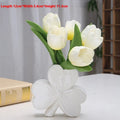 Clover-shaped white porcelain vase in European style on a desktop.