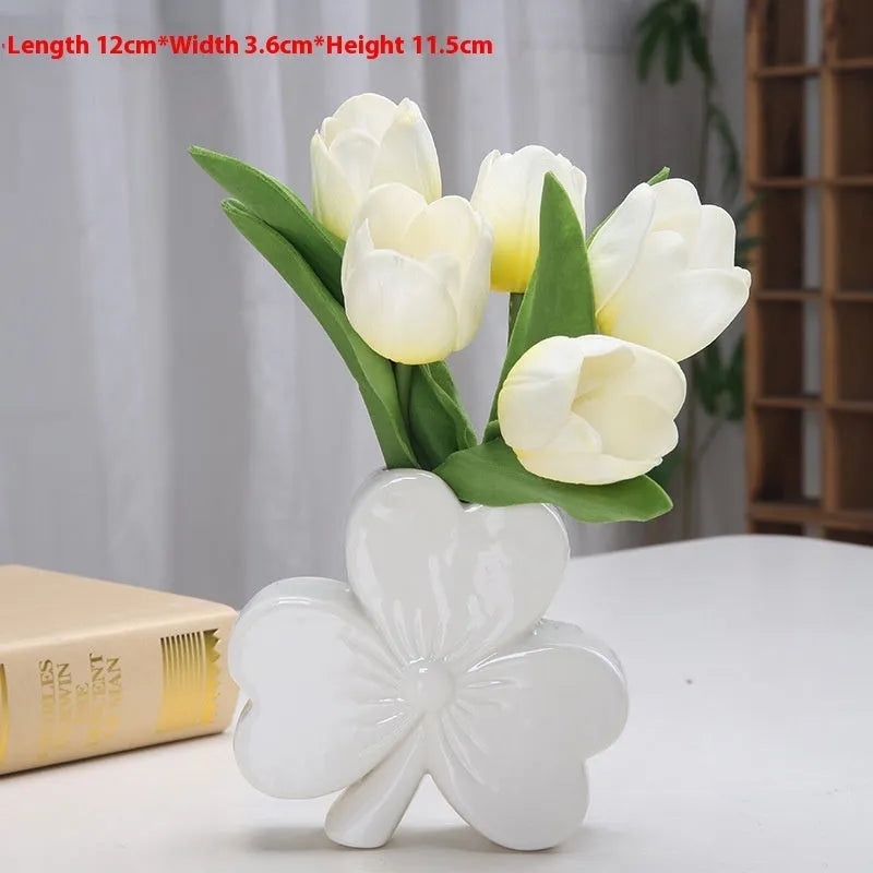 Clover-shaped white porcelain vase in European style on a desktop.