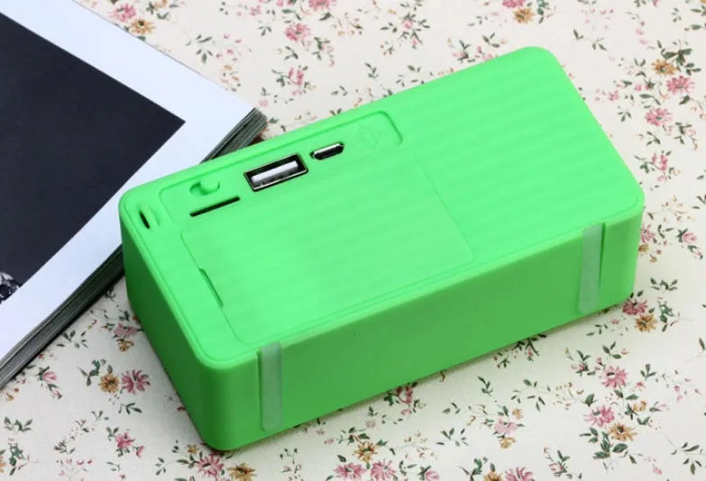 Cannon X3 mini cube-shaped wireless Bluetooth speaker in one of five colours: black, blue, green, red, or yellow.