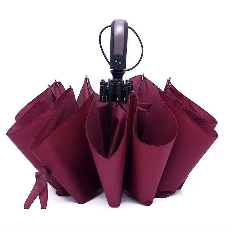Triple-fold black automatic business umbrella with steel frame and rubber handle open.
