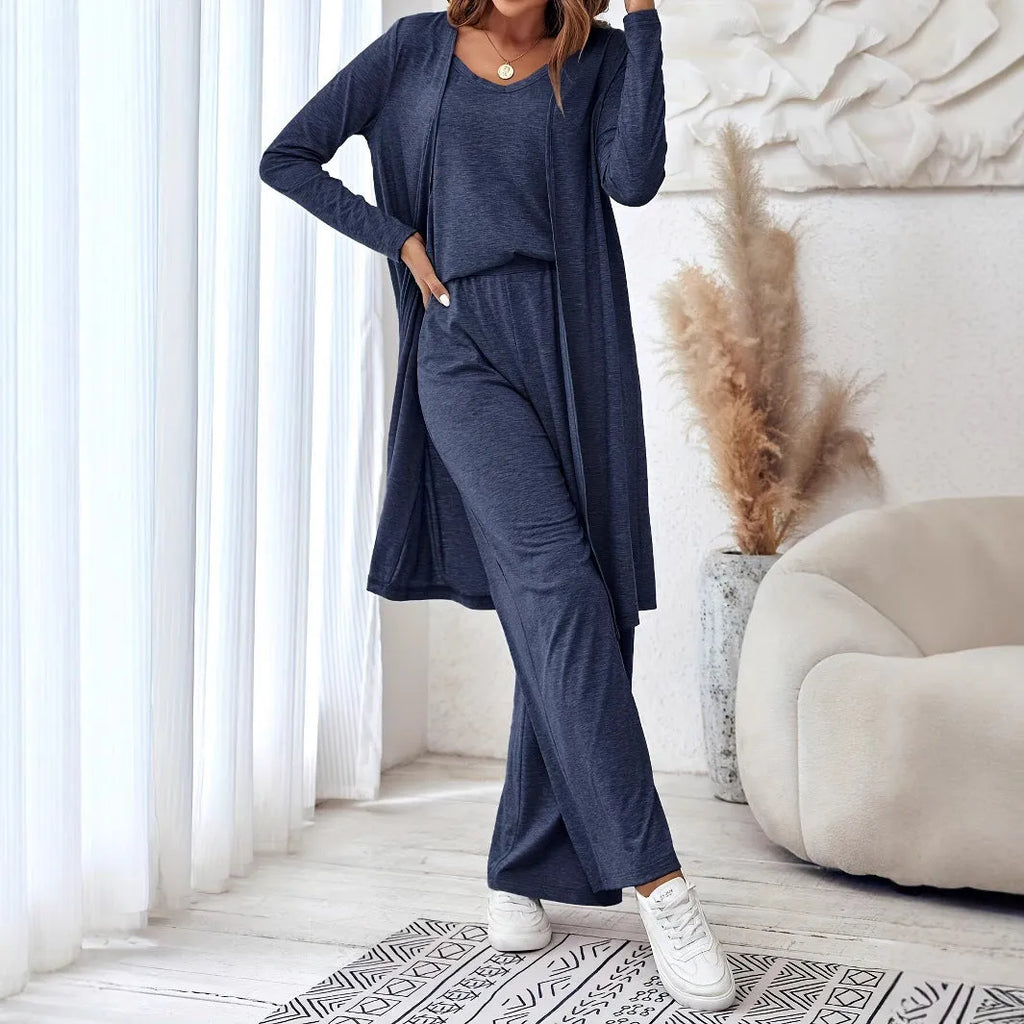 Blue women's three-piece casual suit with cardigan, top, and trousers on a hanger.