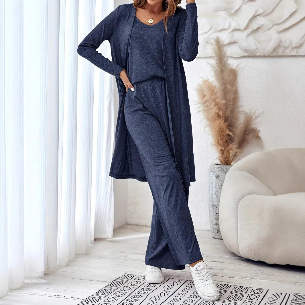 Blue women's three-piece casual suit with cardigan, top, and trousers on a hanger.