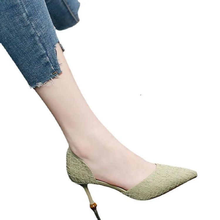 Women's black pointed toe stiletto high heels with a stiletto heel on a plain background.