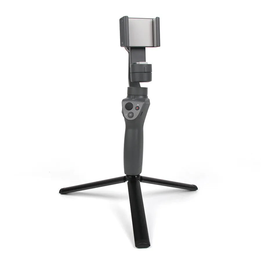 Black aluminium mobile phone tripod stabilizer with PTZ functionality on a table