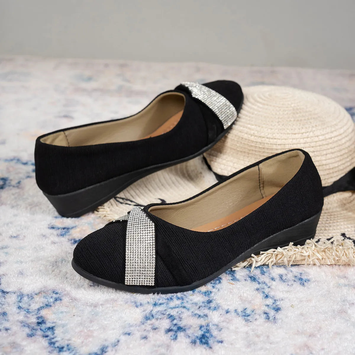Black women's slip-on casual shoes with rhinestones on the fabric upper and a chunky heel.