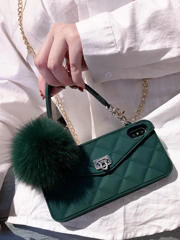 Soft plush TPU iPhone case with a dark green grid texture on a wooden table.