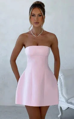 Solid colour backless tube dress with short A-line skirt on a hanger.