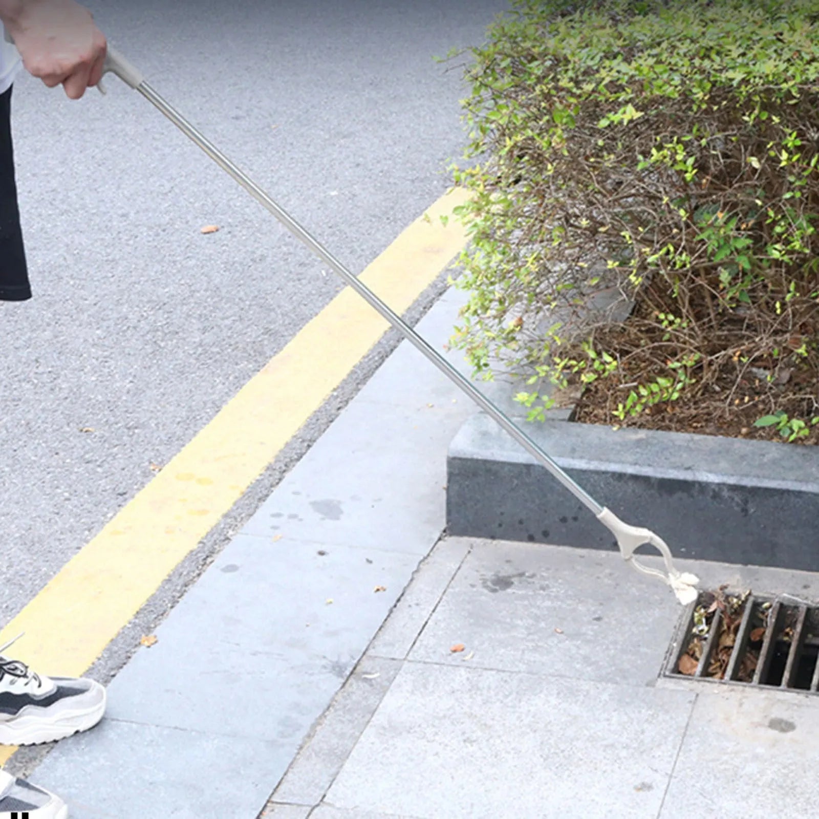 Stainless steel reacher grabber tool with push handle and non-slip chuck, 40cm long.