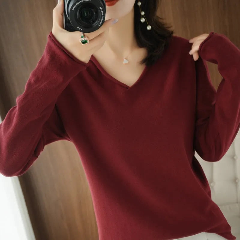 Women's V-neck long sleeve knit top in a macaron colour on a hanger.