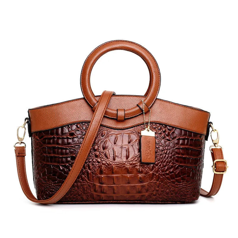 Fabric women's shoulder handbag in multiple colours showing zipper pockets and organisational compartments.