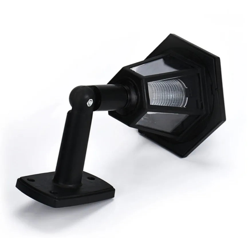 Black hexagonal solar wall lamp with solar panel and LED light for outdoor installation